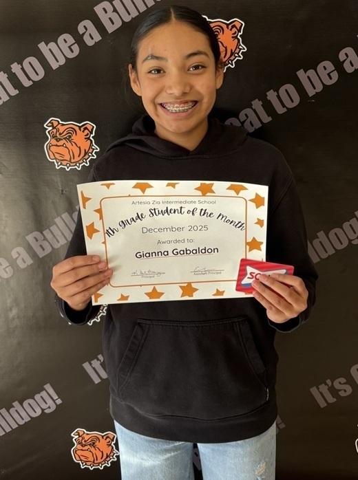 A preteen girl in a black top holds a certificate reading "Seventh-Grade Student of the Month".