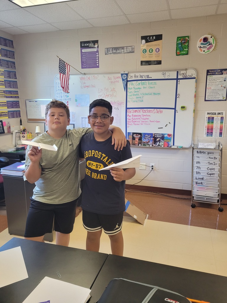 7th graders with their paper airplanes before the contest