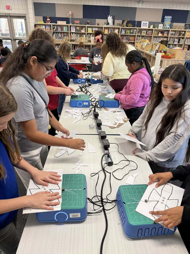 Students cutting out flowerpot maps