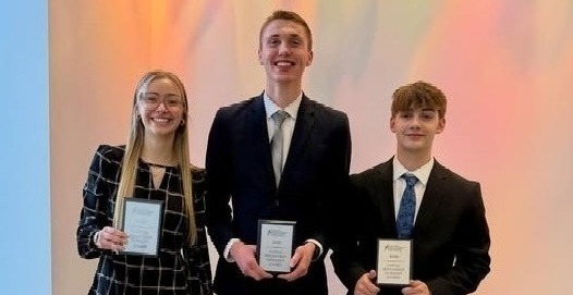 Debate winners holding their awards.