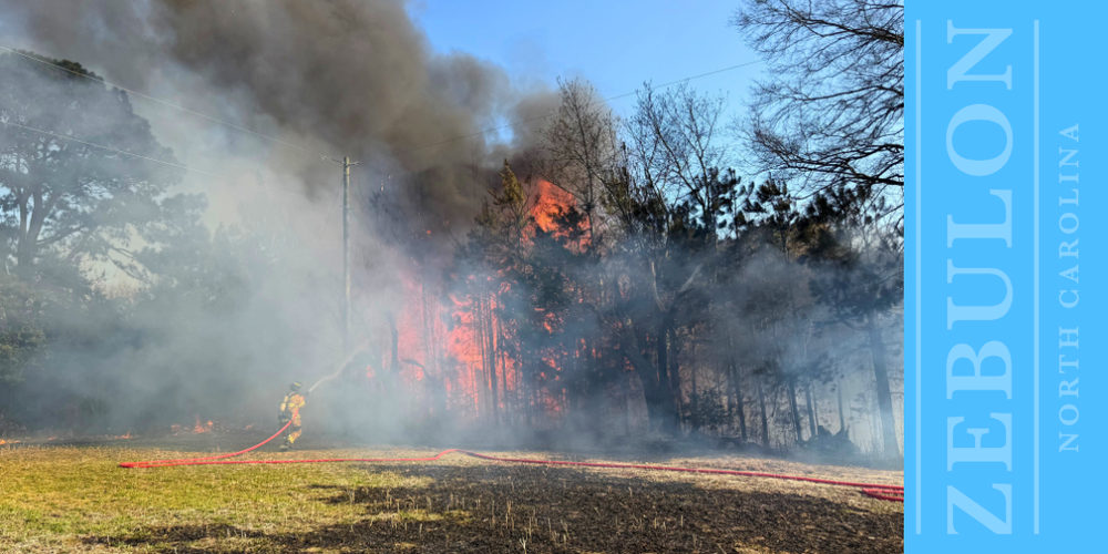 Zebulon Fire Department Responds to Brush Fire on Rosinburg Road ZEBULON, N.C. (March 12, 2026) — The Zebulon Fire Department responded to a fire in the 2400 block of Rosinburg Road on March 11, 2026, after the call was discovered by the Wake County Sheriff’s Office. Crews were dispatched around 5:05 p.m. for reports of a brush fire. When firefighters arrived, they found a fire involving nearby woods and an abandoned home. Firefighters worked to contain and extinguish the fire. No injuries were reported. During the night and into the early morning of March 12, 2026, the fire rekindled and firefighters returned to the scene to continue suppression efforts. Crews remained on scene working to ensure the fire was fully extinguished. The Zebulon Fire Department was assisted by Hopkins Fire Department, Pilot Fire Department and Ferrells Fire Department. The Wake County Fire Marshal’s Office is investigating. Fire Chief Perry reminds residents to be mindful of the current dry conditions. Even small actions, such as discarding a cigarette into a burn barrel or onto dry grass, can ignite a fire that may quickly spread to nearby woods or structures. Chief Perry also encourages residents to use caution when grilling or using outdoor fire pits. Grills should be placed at least 10 feet away from homes, decks and other structures. Residents should keep a water hose or bucket of water nearby when grilling or using a fire pit and ensure fires are completely extinguished when finished. If using a burn barrel, the surrounding ground should be wet and water should be readily available to fully put out the fire. If you see smoke or fire, report it immediately by calling 911 so emergency crews can respond as quickly as possible. The Zebulon Fire Department appreciates the assistance of all responding agencies and remains committed to protecting lives and property in the community it proudly serves.