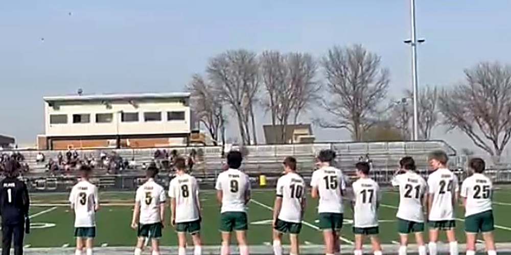 Members of the KCHS-Amherst boys soccer team line up before kickoff, including Wyatt Anderson (#3), Easton Malleck (#5), Kristian Marchese (#9), Breckon Malleck (#17), and Talen Watson (#21)