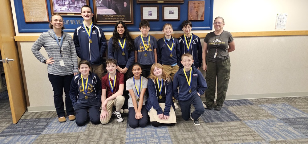 10 students and their science teachers with medals
