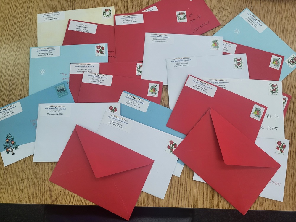 Blue red and while enveloped addressed and stamped with carrying holiday wishes to shut ins in our community