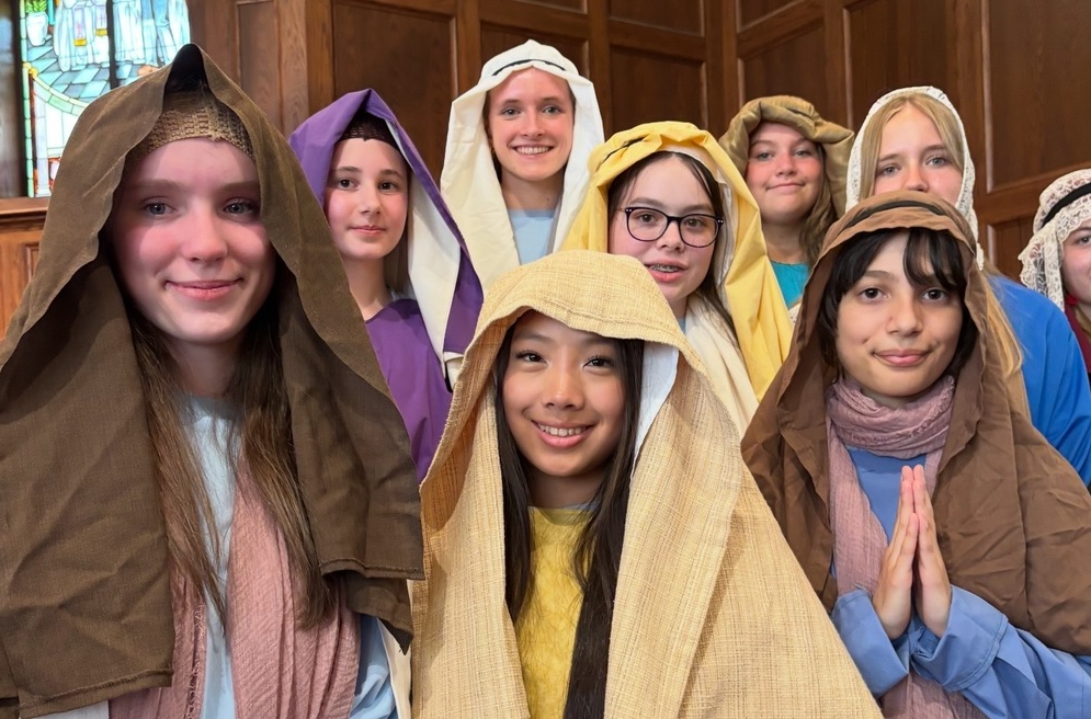 8th grade students dressed in living stations attire. 