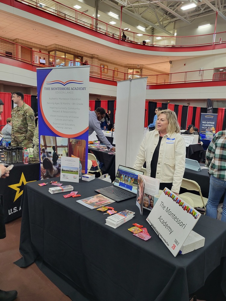 women standing behind a table at a career fair