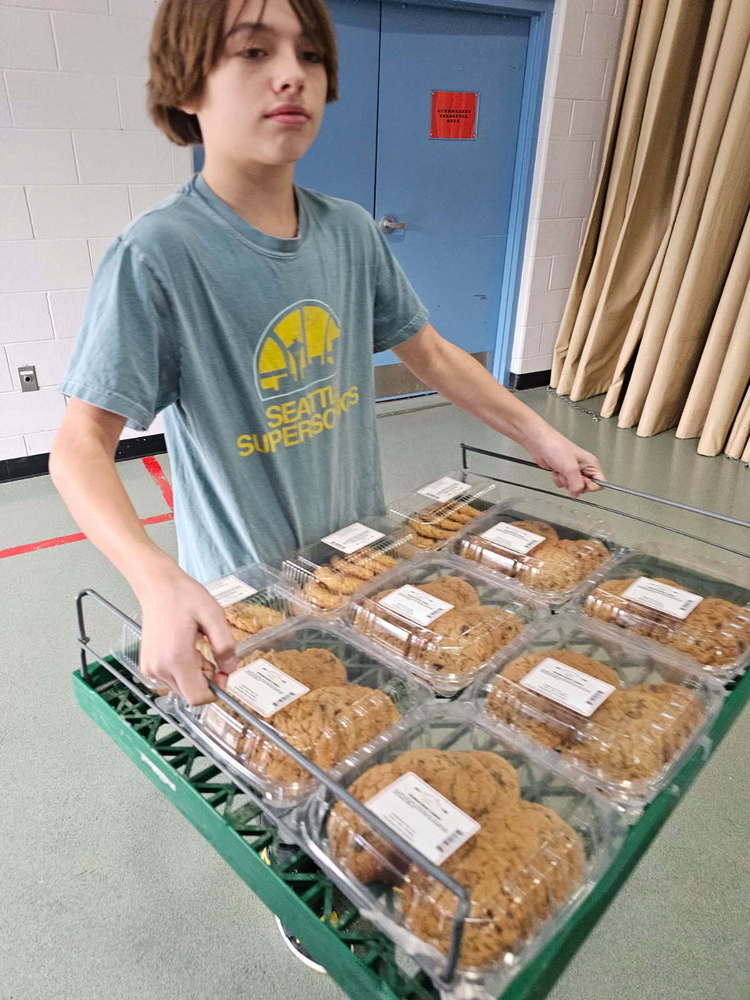 JH student carrying tray of cookes