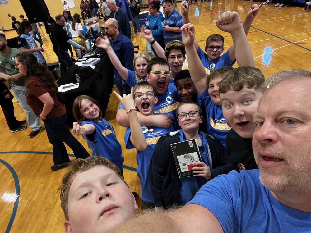 team of boys cheering their victory in a gym