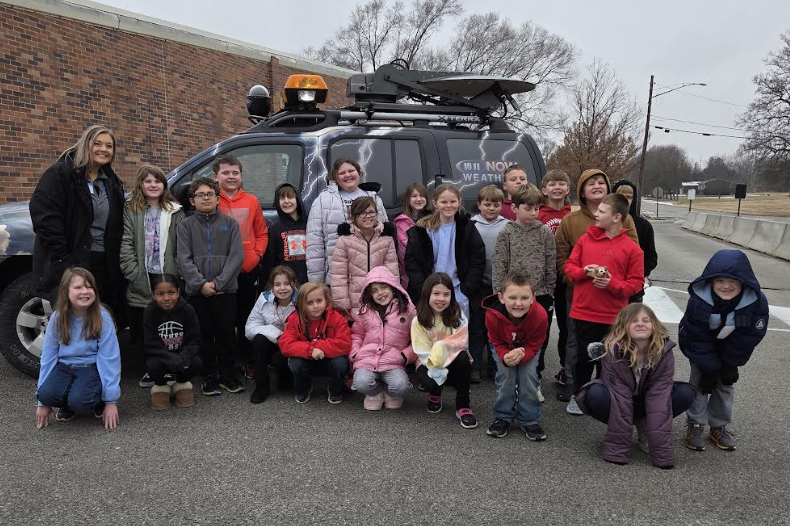 Southern students posing with the 1011 Weather Shield vehicle and meteorologist to cap off their weather unit. 