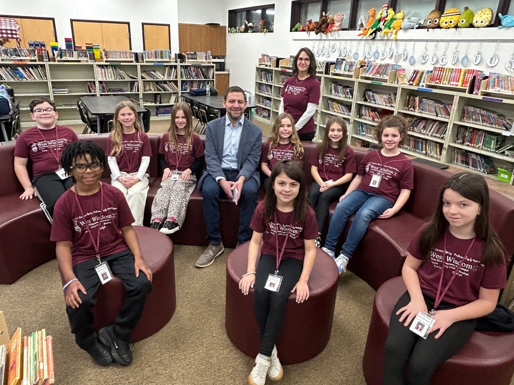 3rd grade West Wisdom Staff with NBC Reporter in school library