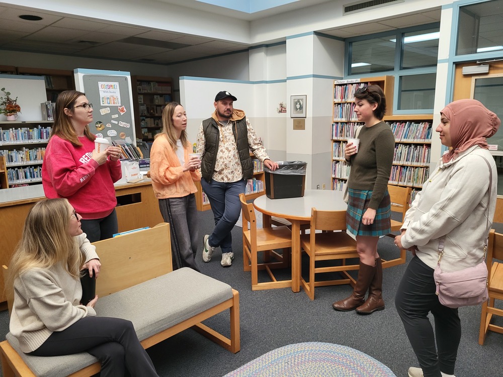Parents in TMA library tlaking and having coffee