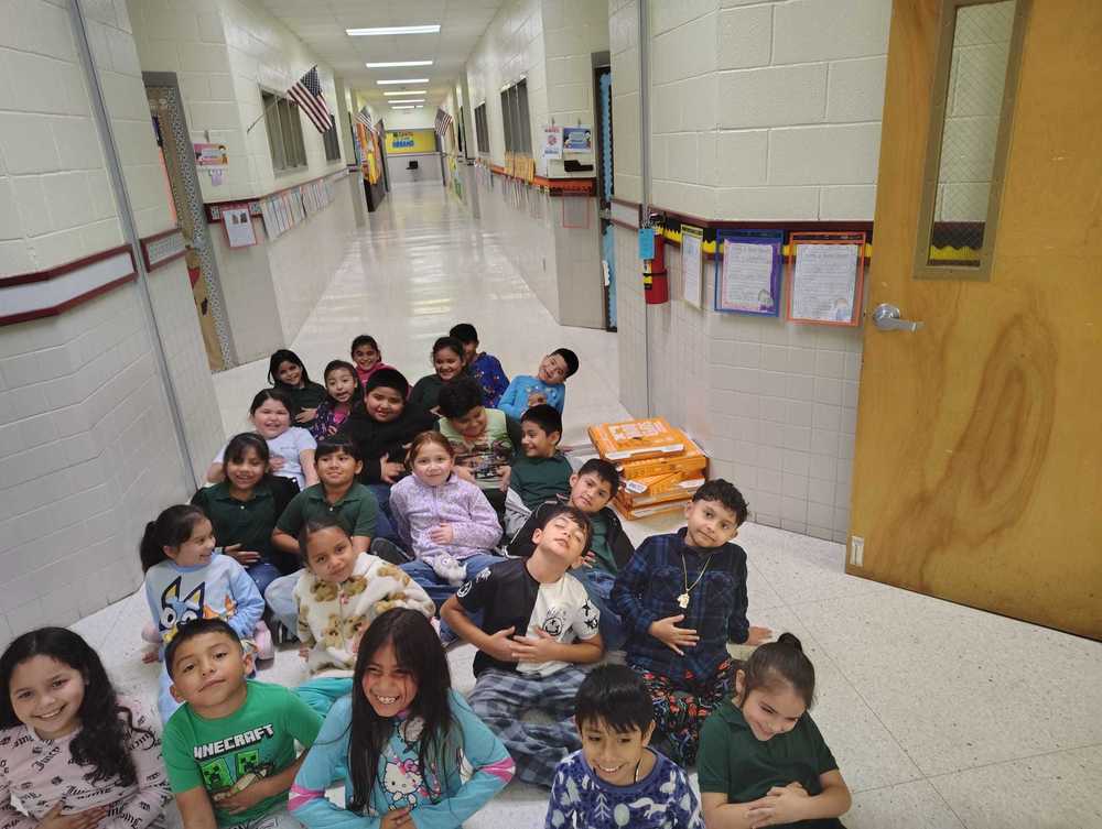 Students posing with pizza
