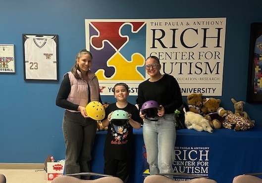 Emerging Leaders drop off bike helmets to Rich Center for Autism