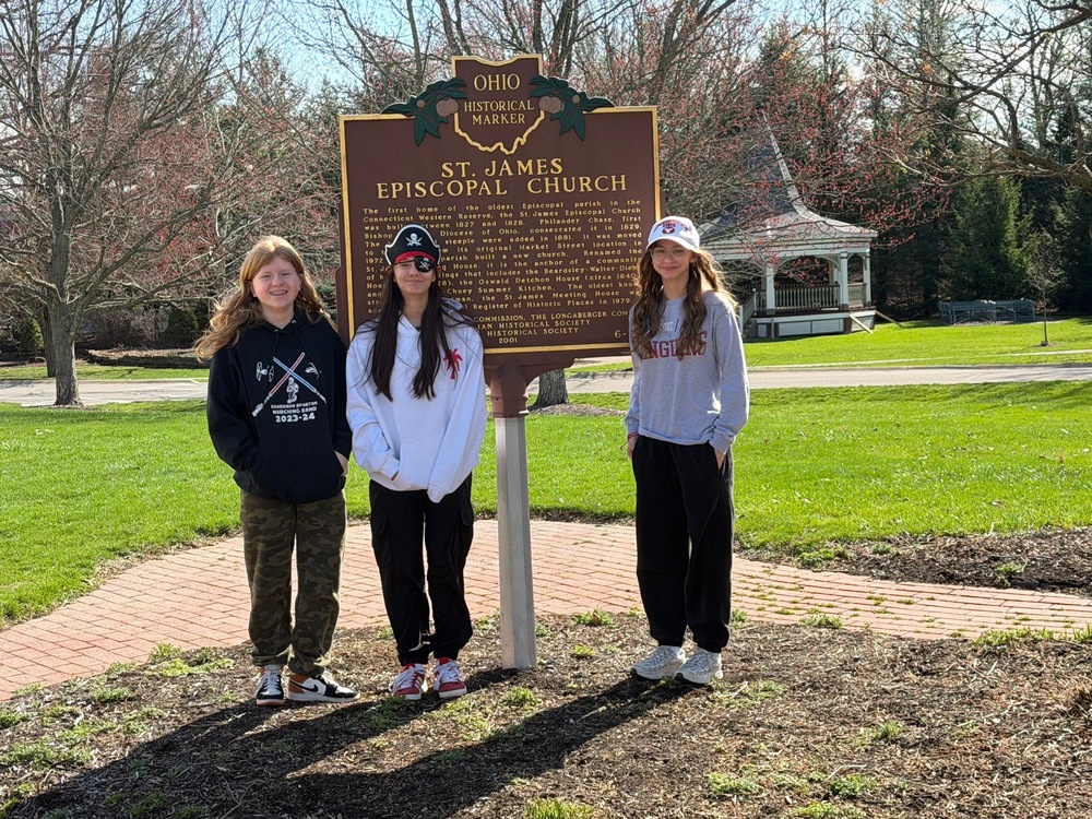 students standing in front of historical marker for St. James Church