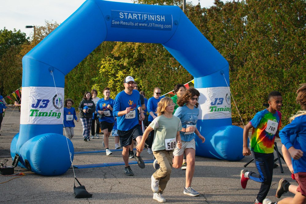 Runners coming through a starting line