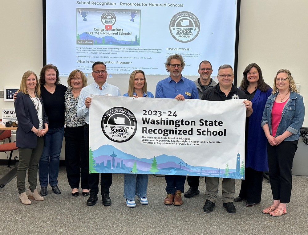 Superintendents from different school districts holding the banner for WA Recognized Schools