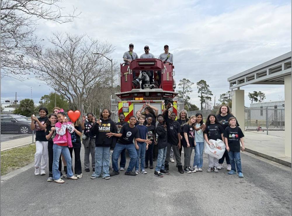 Children standing with fire truck 