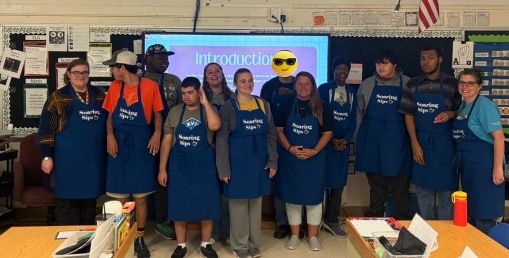 Students in Palmer’s Pac pose together during their Soaring Sips interview, smiling and celebrating their student-run coffee shop at Margaret K. Lewis School.