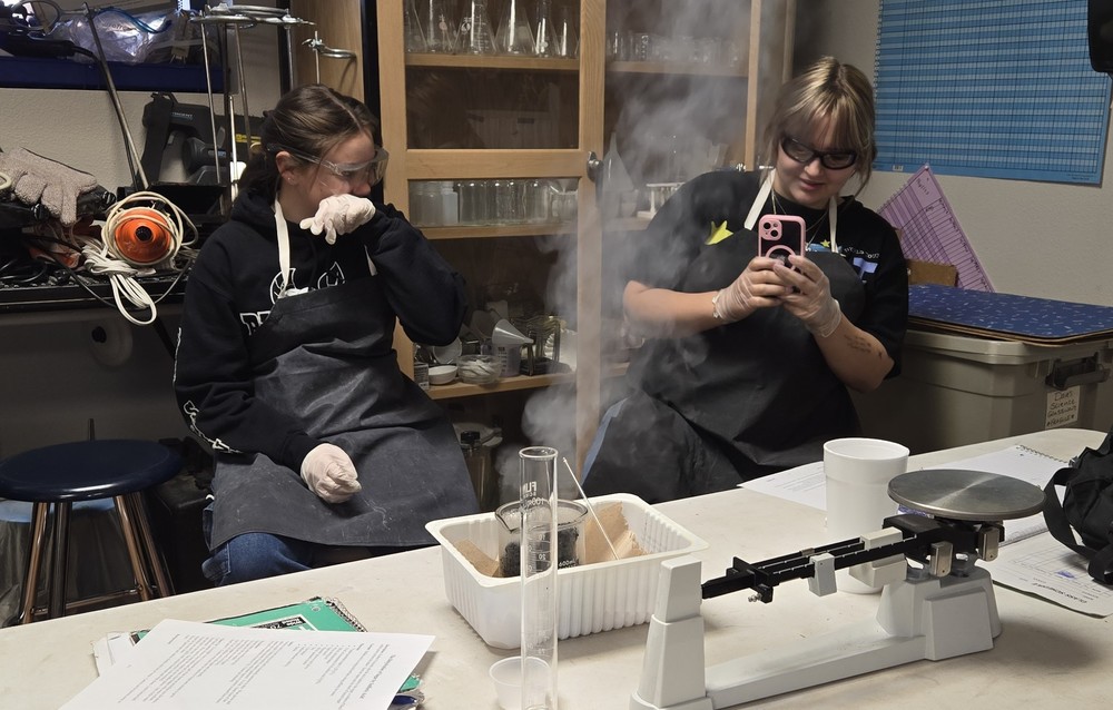 Student's laughing while doing experiment
