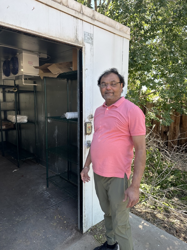 Man from Corral Market helping us load the freezer