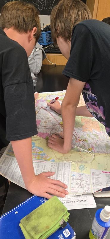 Students drawing on map