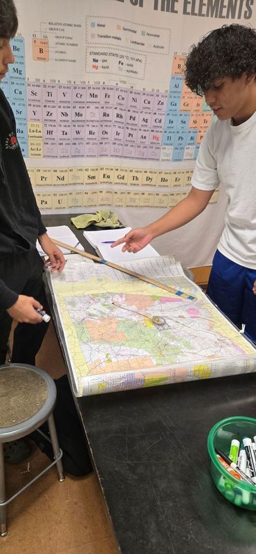 Students pointing at a map