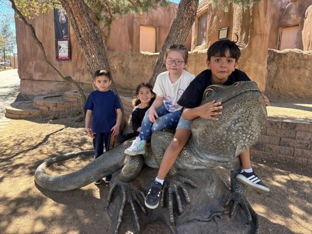 1st grade on sitting on lizard statue