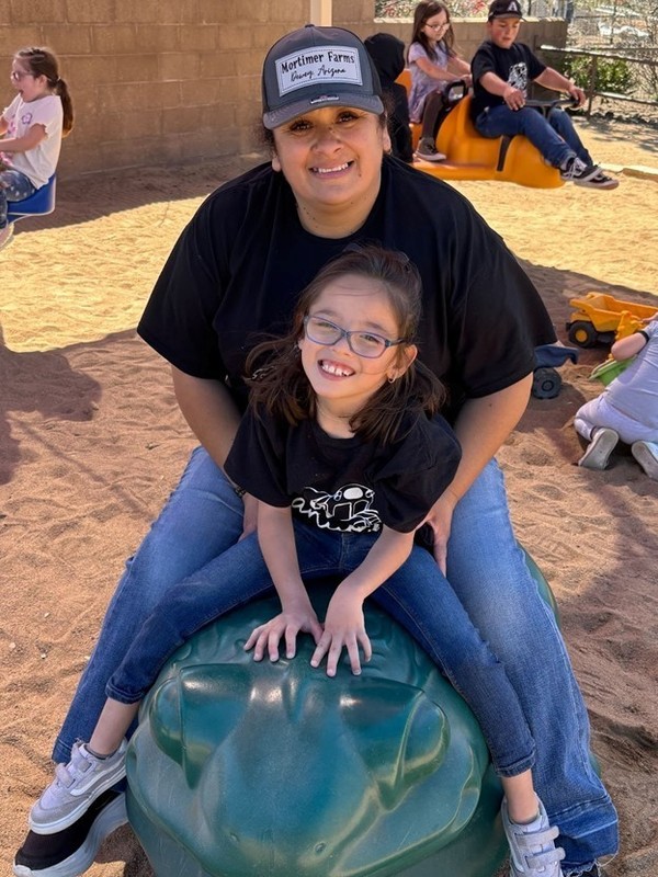 Staff and student posing for a picture