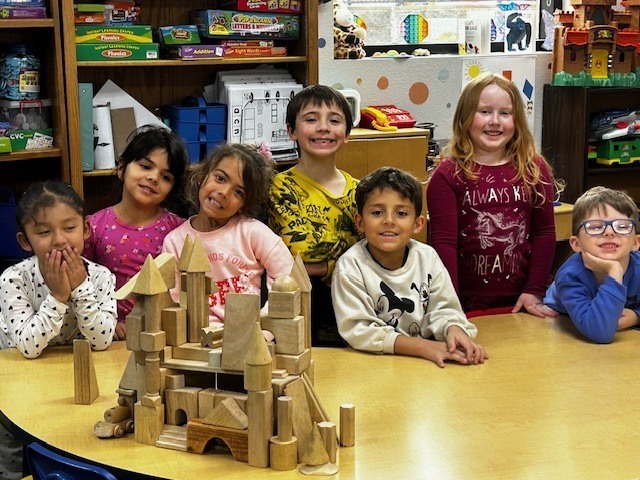 Kindergarteners posing with their block creation