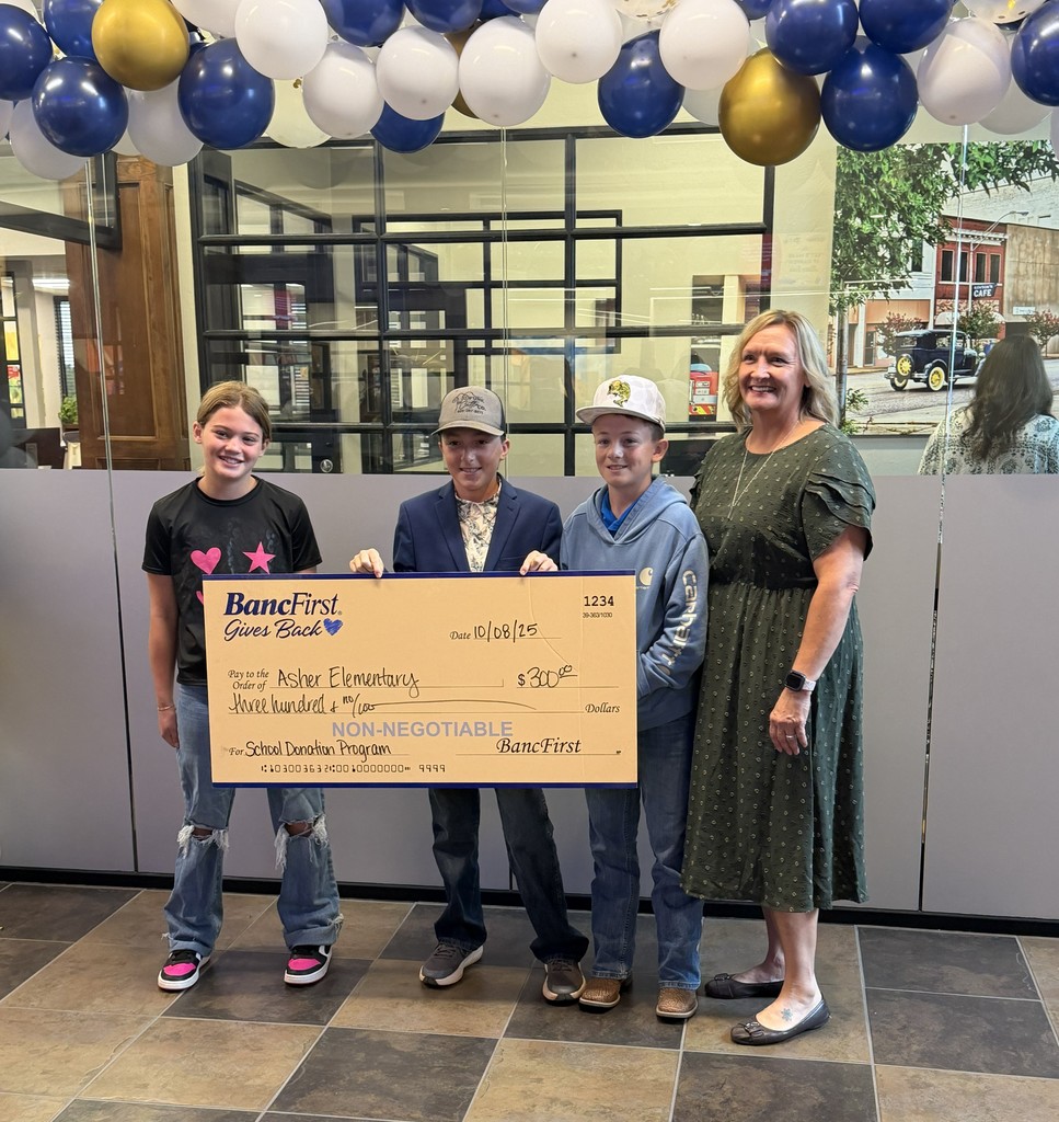 Mrs. Milburn and students accepting grant.