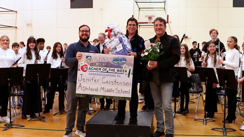 Teacher Jenifer Carstensen receiving the Teacher of the Week award from Rogue Credit Union 