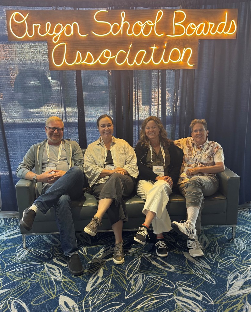 Board members sitting below a sign that reads Oregon School Boards Association