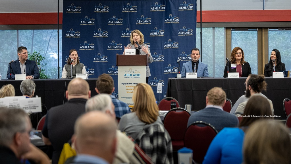 Panelists sitting at tables