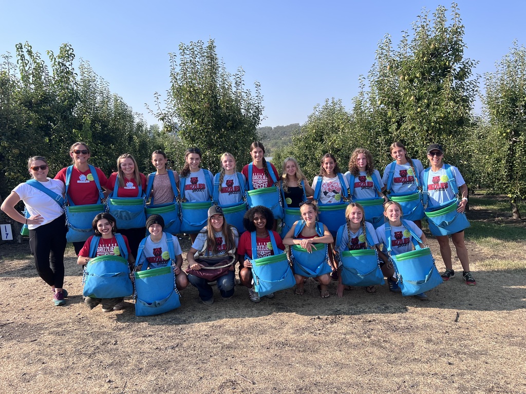 Girls team in front of pear trees