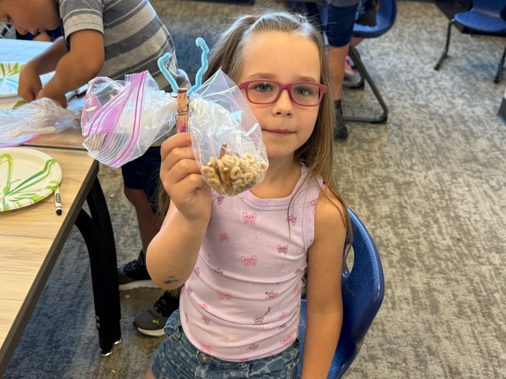 Making art with snacks! This is a cheerios butterfly.