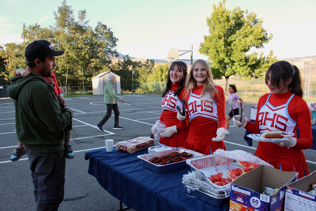 Cheerleaders serve hot dogs