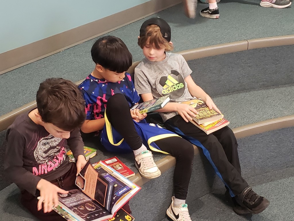 Students read their Booksgiving books together