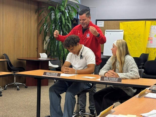 Student receiving a graduation cord