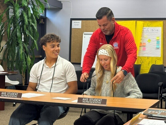 Student receiving a graduation cord