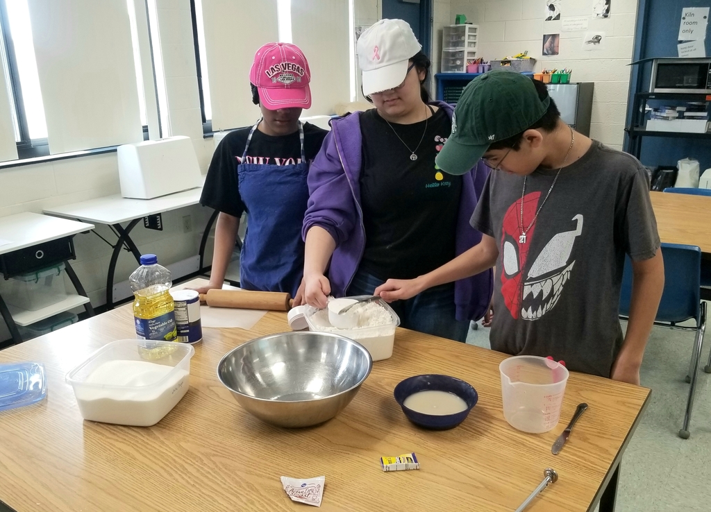 Skylar Redmond, Nom'Aria Barajas and Robert Cancino Dennis measuring ingredients for their pizza dough.
