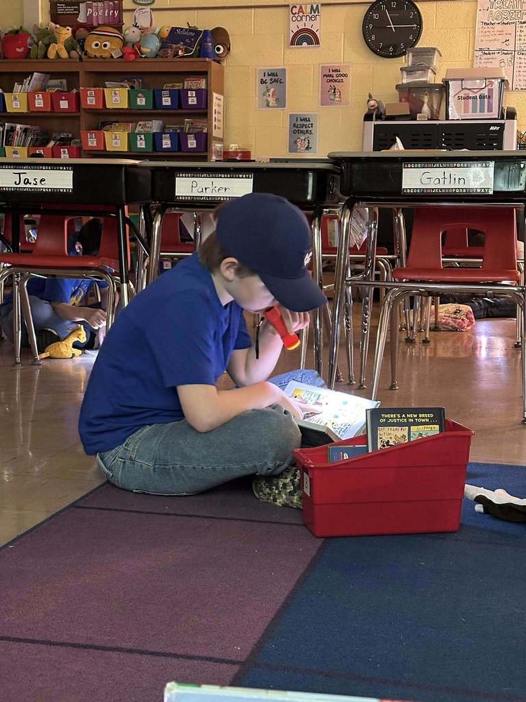 Students reading with flashlights