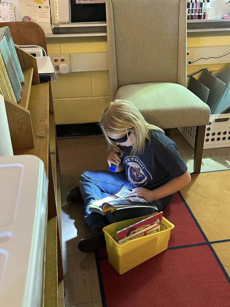 Students reading with flashlights