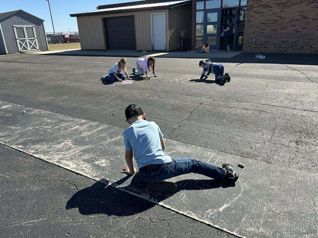 Students using chalk to draw math problems