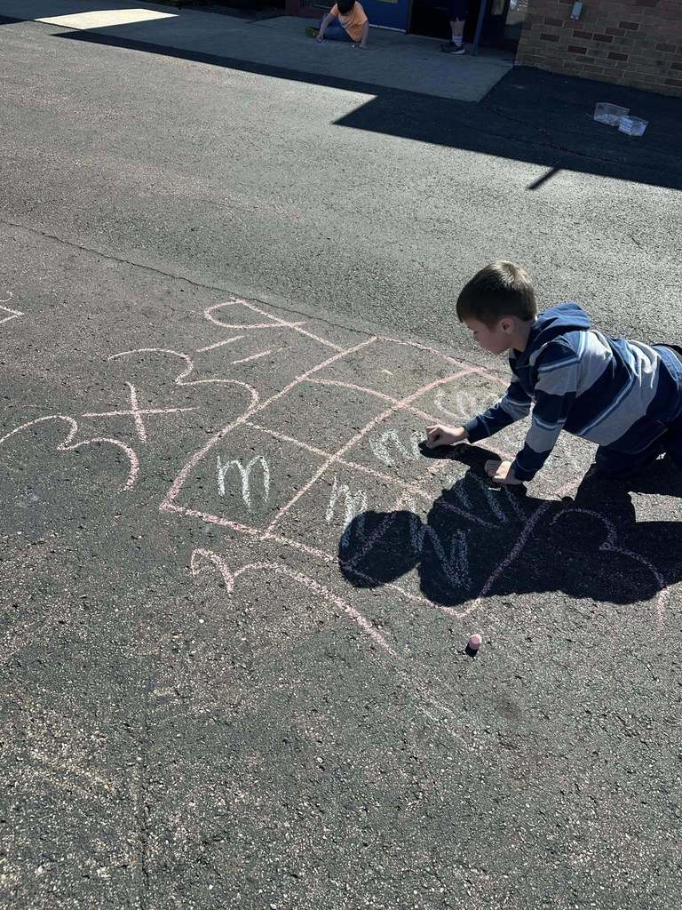Student using chalk to draw math problems