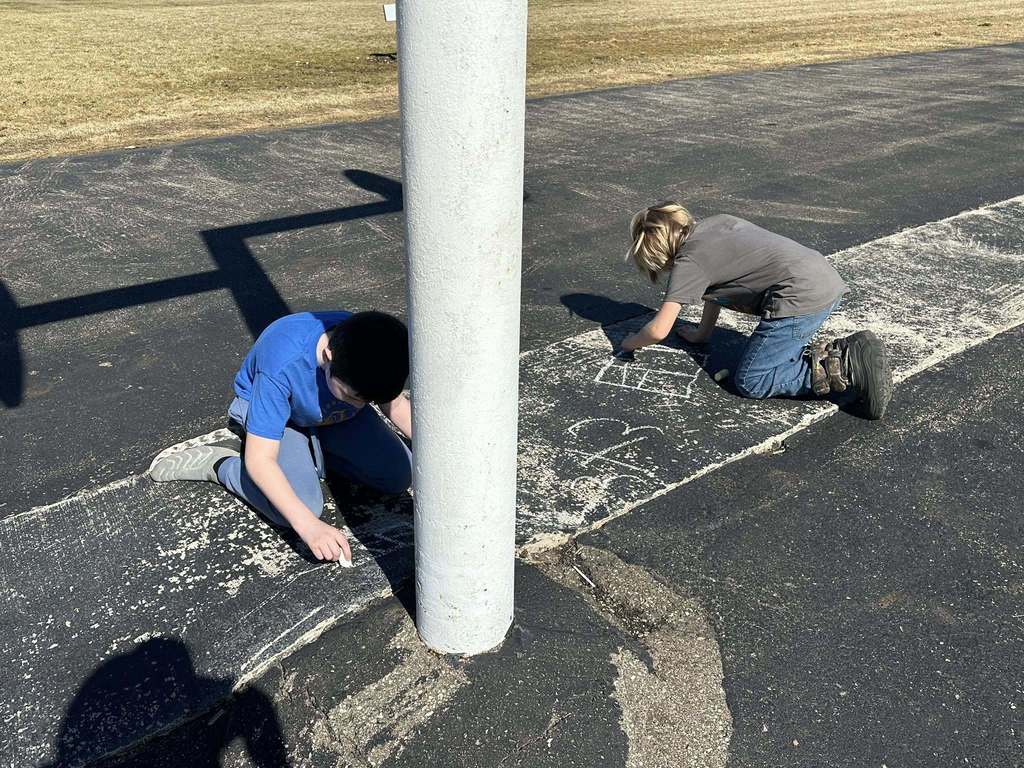 Students using chalk to draw math problems