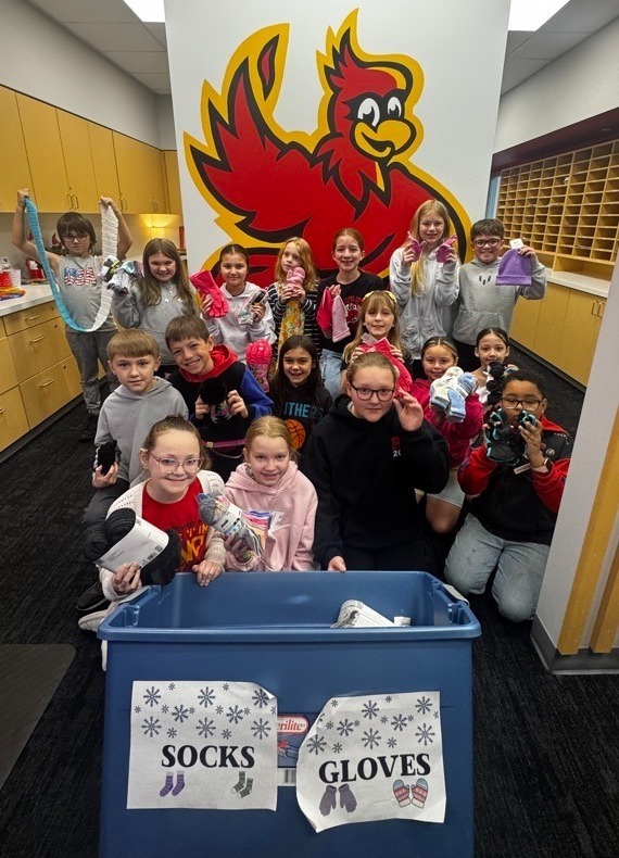 Photo of AES Student Council Members showcasing their Salvation Army Donation of 200 pairs of socks and gloves.  