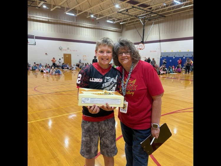 two people one holding a box of donuts