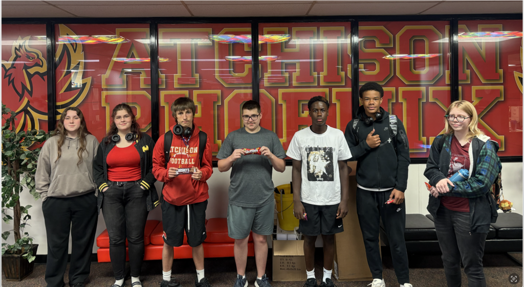 Students standing in front of windows