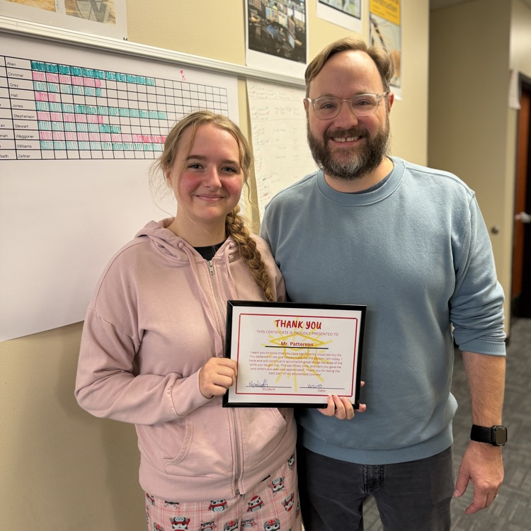 two people with an award 