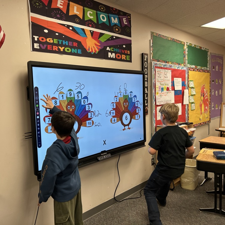 two students at a white board 